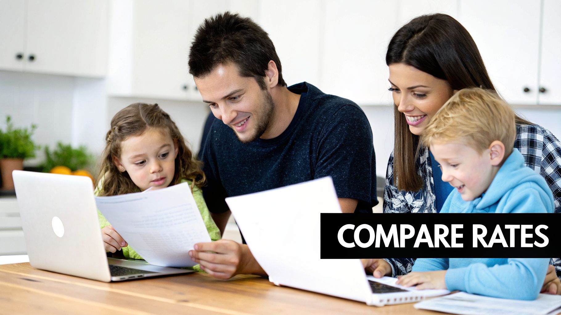 Smiling family of four comparing rates on laptops and papers at a kitchen table.
