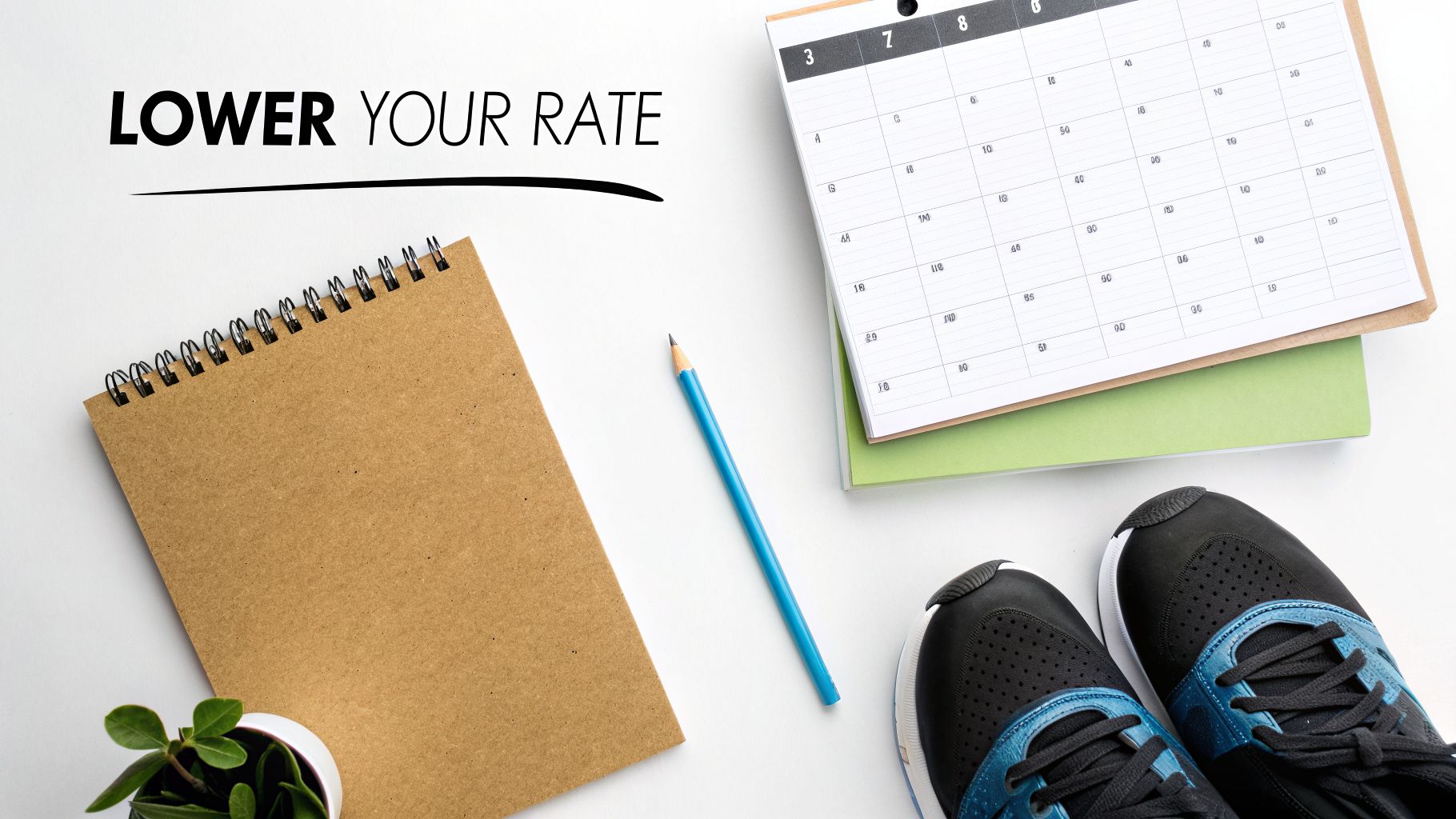Flat lay of a desk with 'LOWER YOUR RATE' text, a notebook, pencil, calendar, and sneakers.