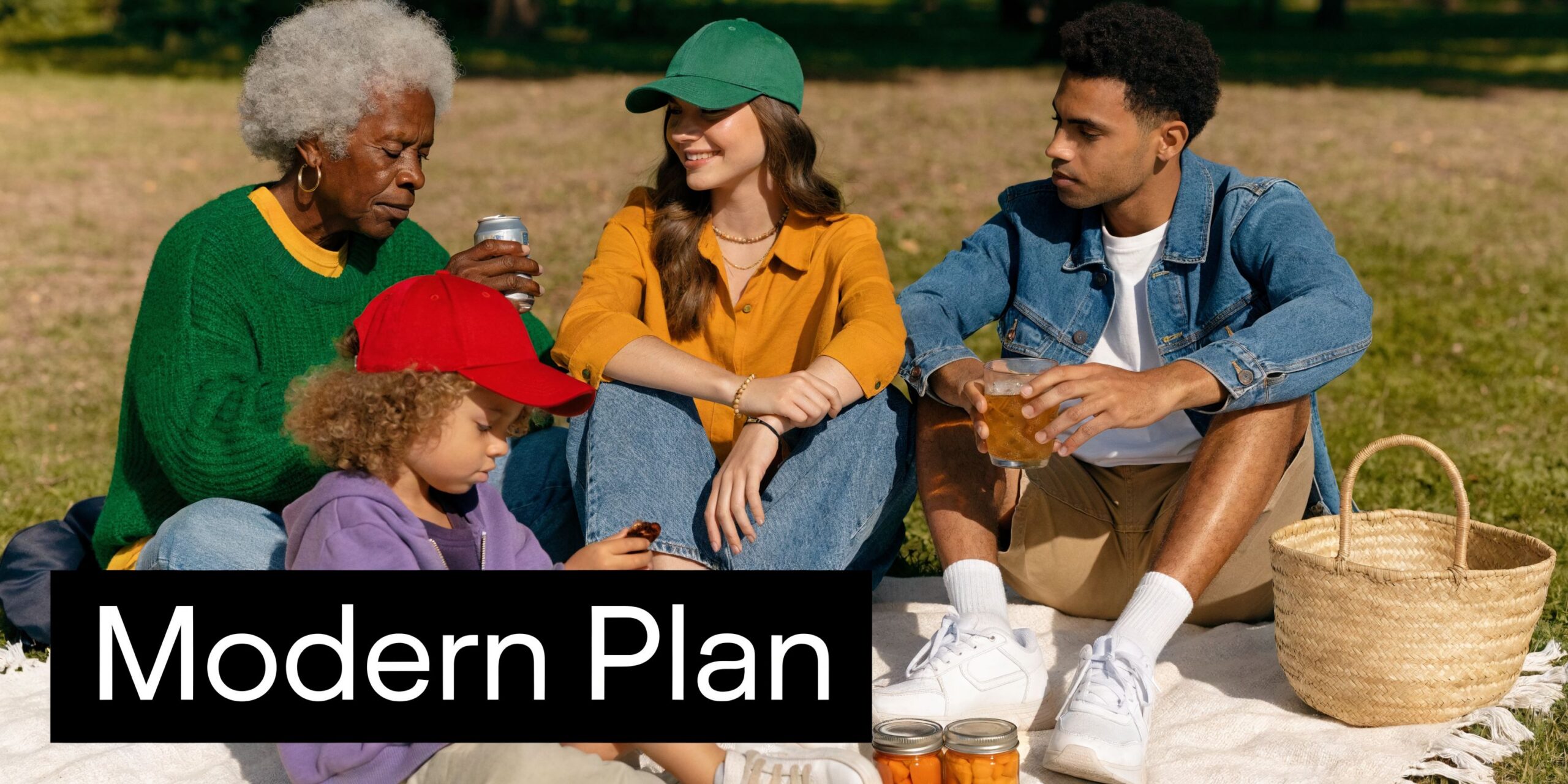 A multi-generational family enjoys a sunny picnic on a park blanket with food and refreshing drinks.
