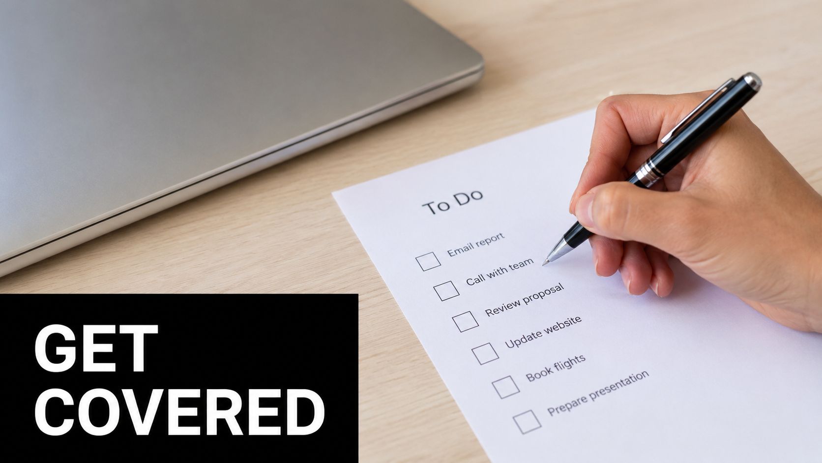 A hand holding a pen over a to-do list with checkboxes on a wooden desk near a laptop.