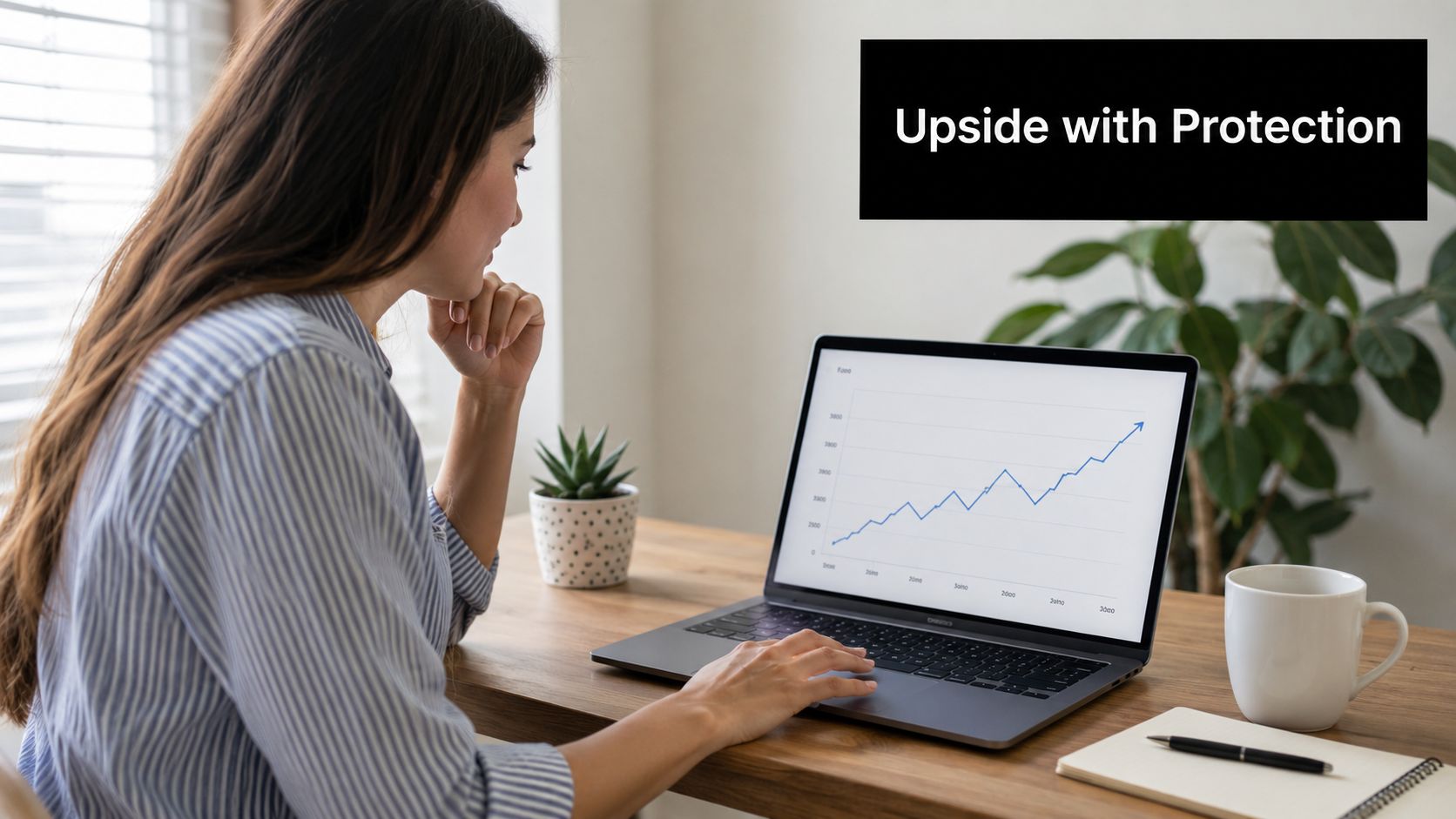A woman working on a laptop at a desk viewing a positive upward trending financial growth chart.