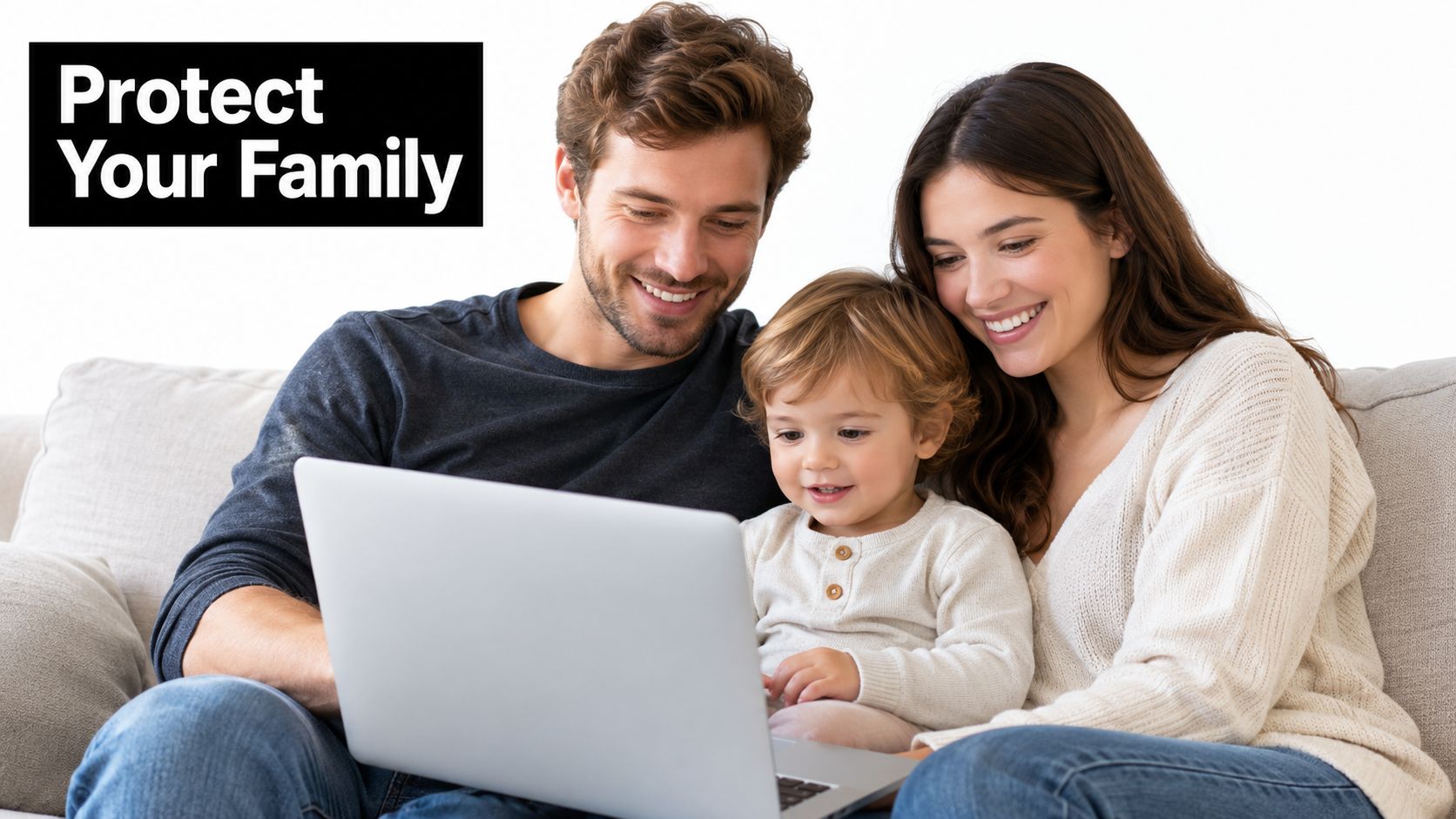 A happy family of three, parents and their child, looking at a laptop screen while sitting together.